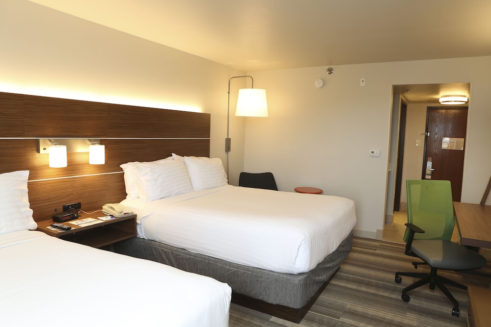 hotel room with two beds and a desk in it