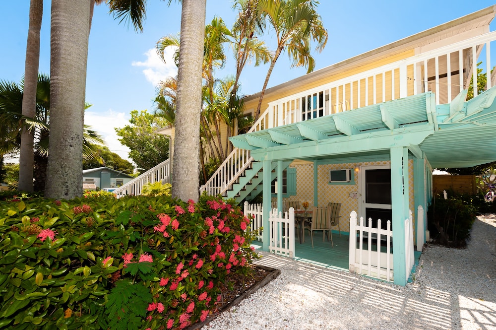 Tropical house exterior with palm trees and flowers