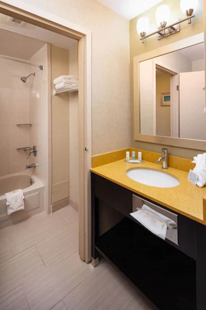 bathroom with a sink, shower, and bathtub