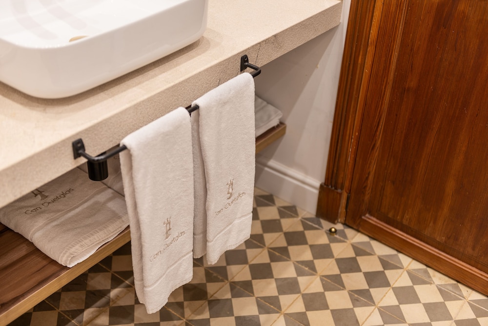 bathroom with a sink and towels hanging on the wall