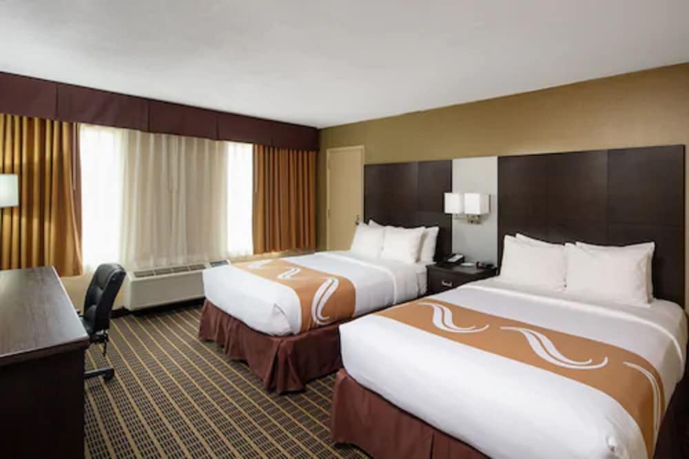 hotel room with two queen sized beds and a desk