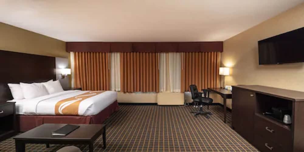 hotel room with a king size bed and flat screen tv