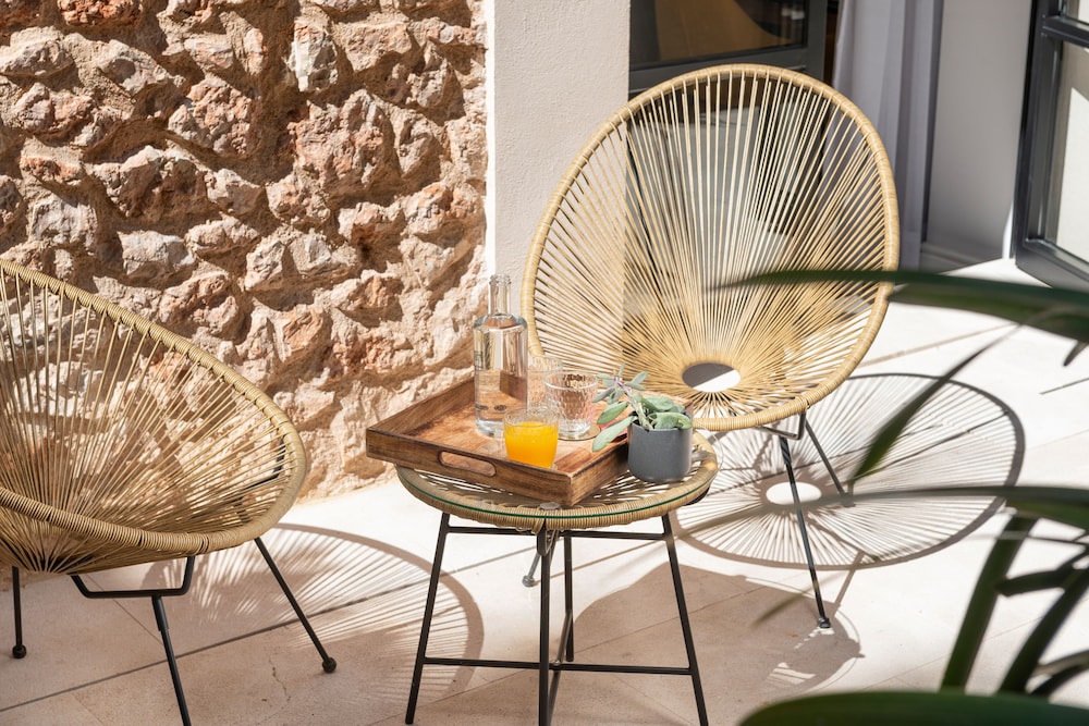 pair of wicker chairs and a glass of orange juice