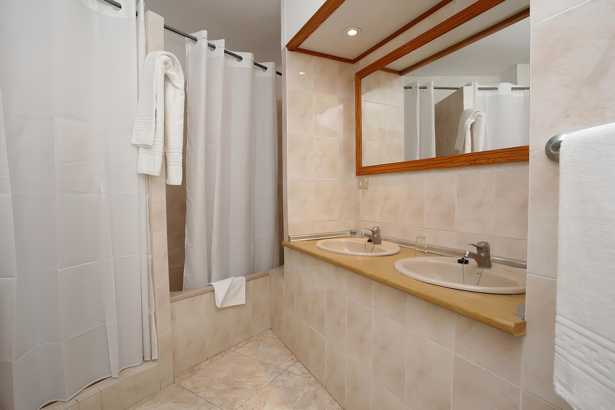 Relax in a spacious and stylish bathroom retreat.