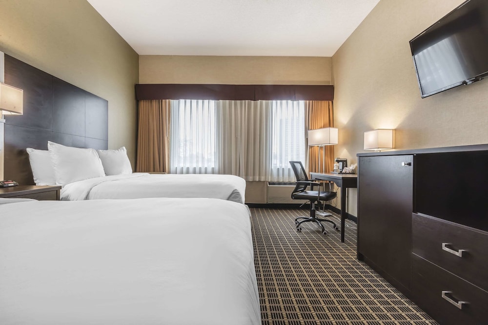 hotel room with two beds and a flat screen tv