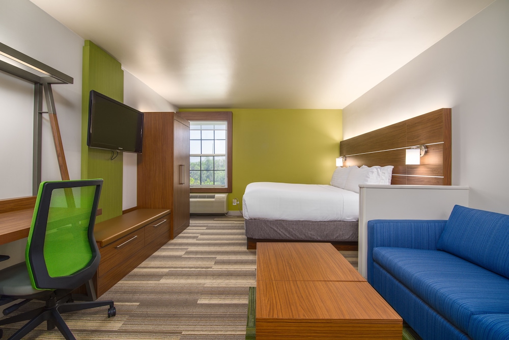 hotel room with a blue couch and a green chair