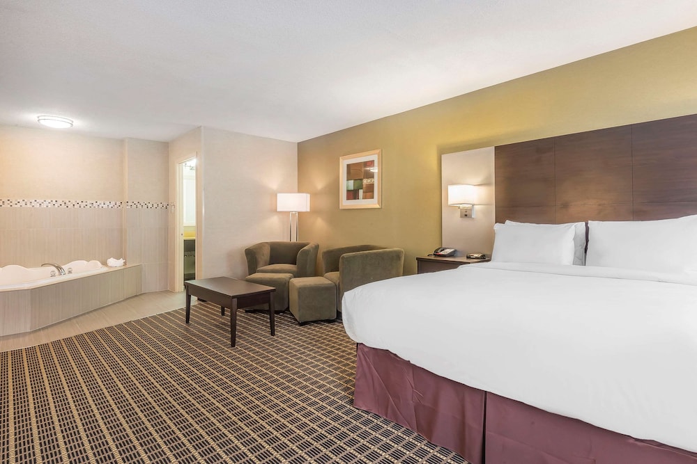 hotel room with a jacuzzi tub in the corner