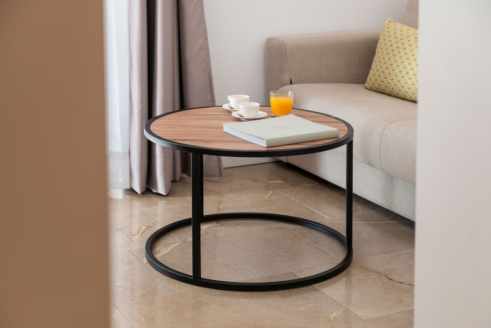 coffee table with a book and orange juice on it