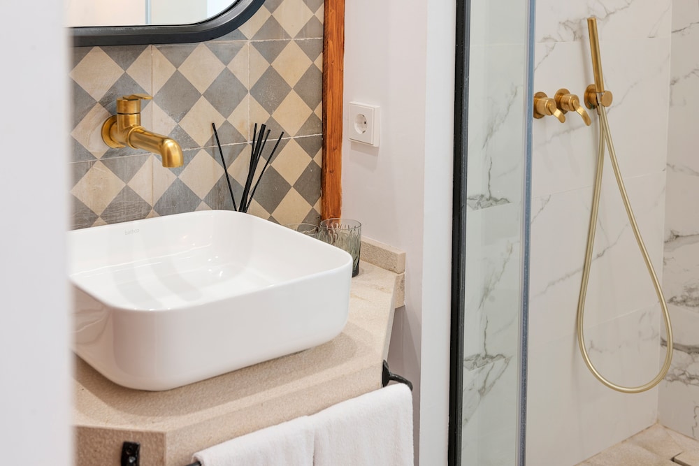 bathroom with a white sink and a walk in shower