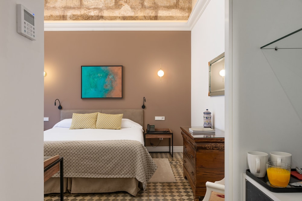 bedroom with a bed and a painting on the wall
