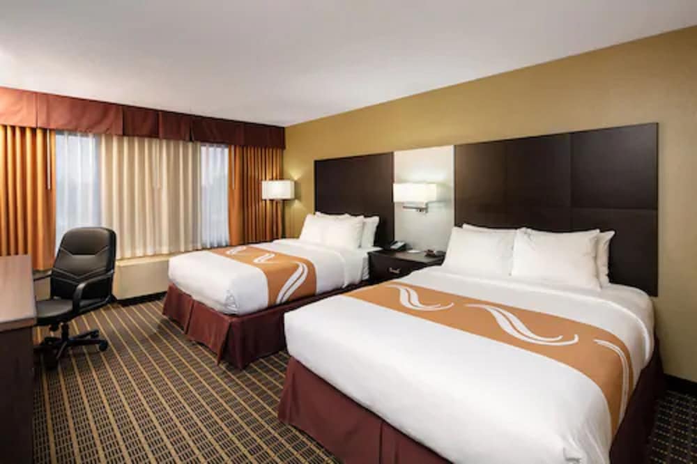 hotel room with two queen sized beds and a desk
