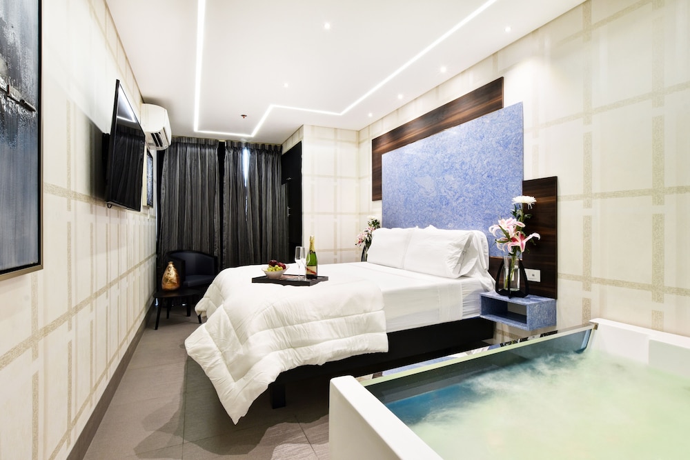 Room with hot tub and balcony