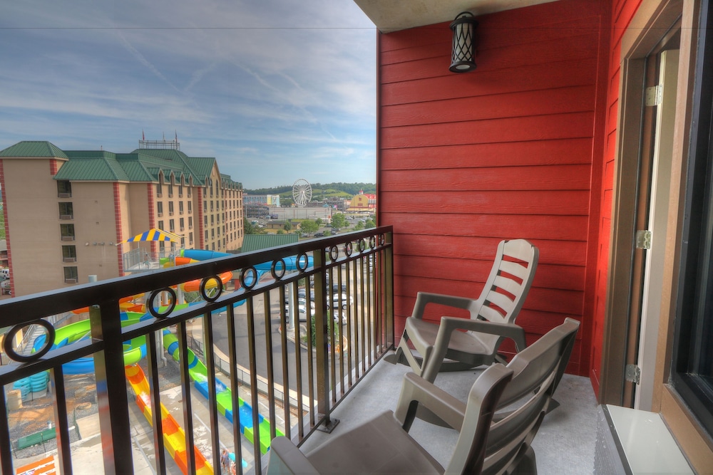 Hotel balcony with chairs overlooking amusement park