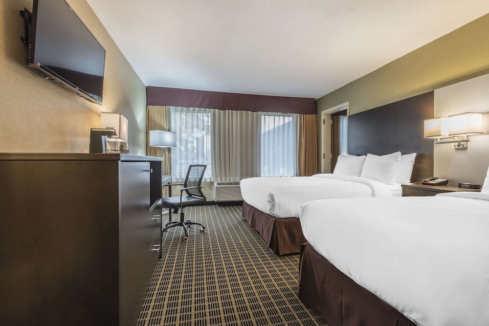 hotel room with two beds and a flat screen tv