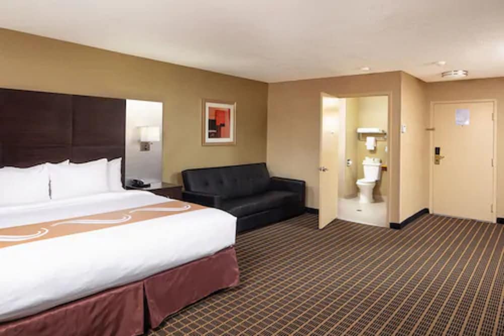 hotel room with a king size bed and a couch