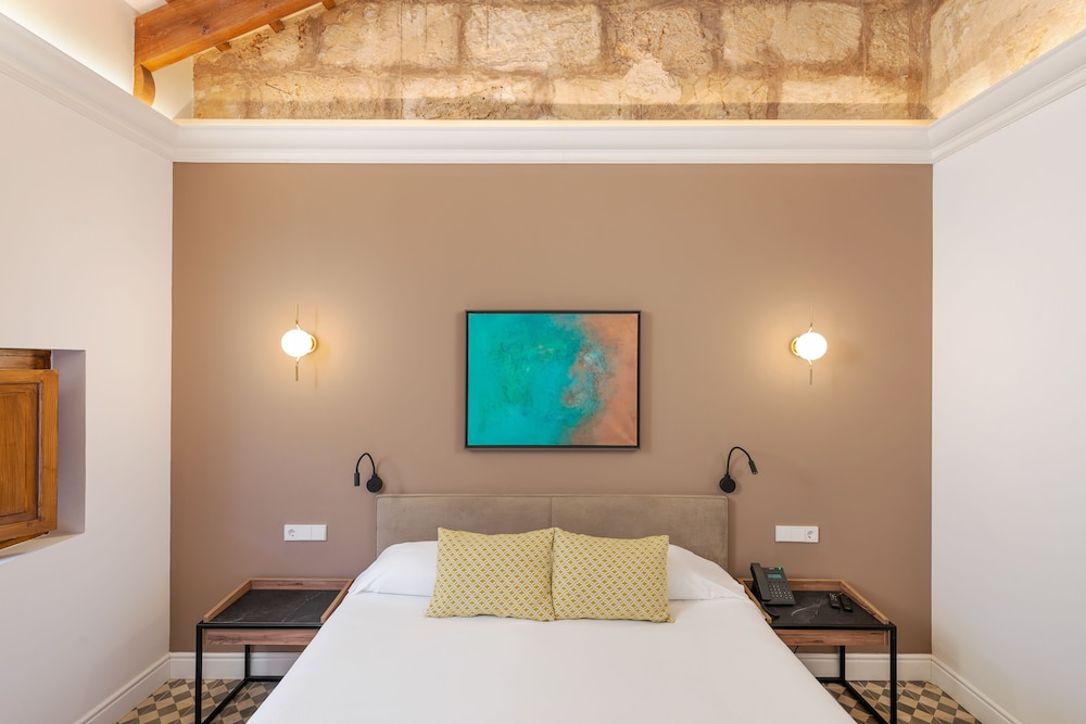 bedroom with a bed and a painting on the wall
