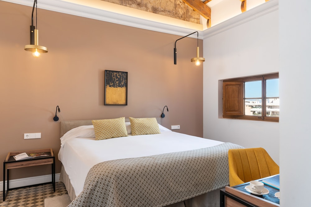 shot of a bedroom with a bed and yellow chair