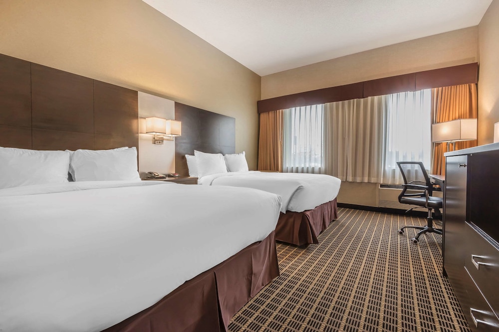hotel room with two beds and a flat screen tv