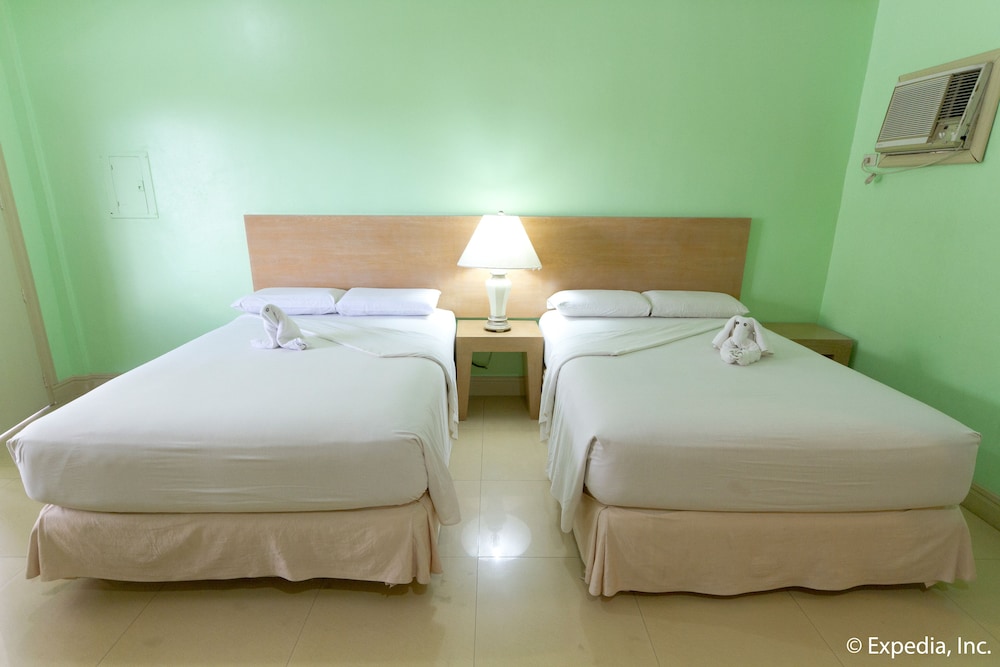 twin bed with two towels on it? and the lamp has been turned off