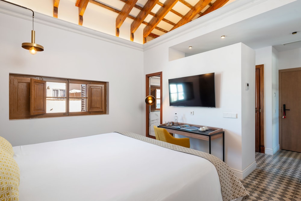 bedroom with a bed, desk, and flat screen tv