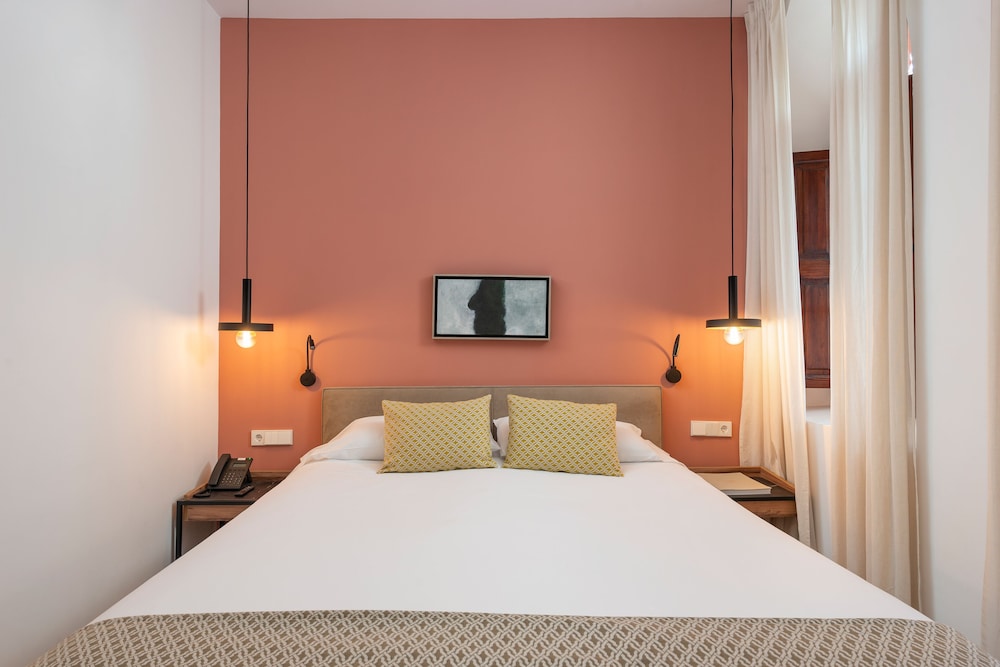 bedroom with a bed and two lamps on either side of the bed