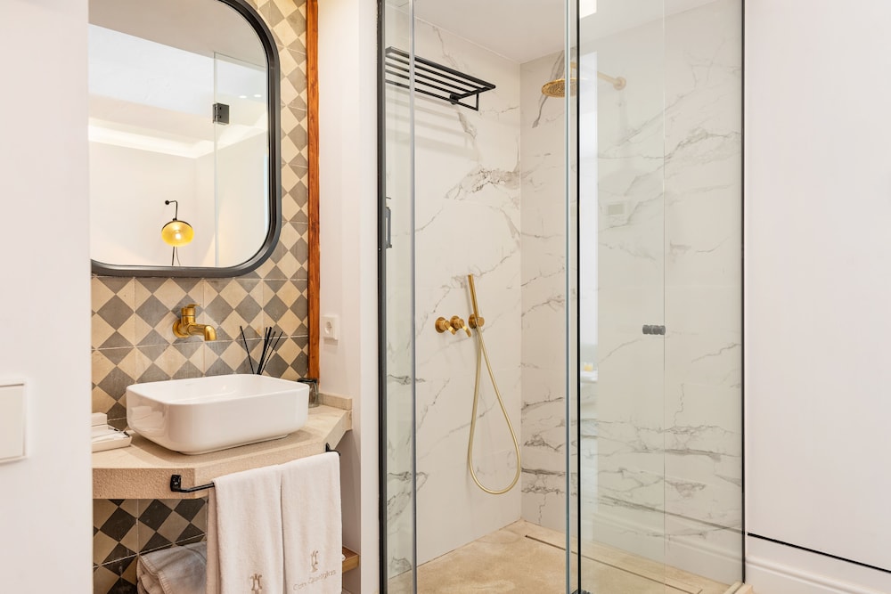 bathroom with a walk in shower and a white sink