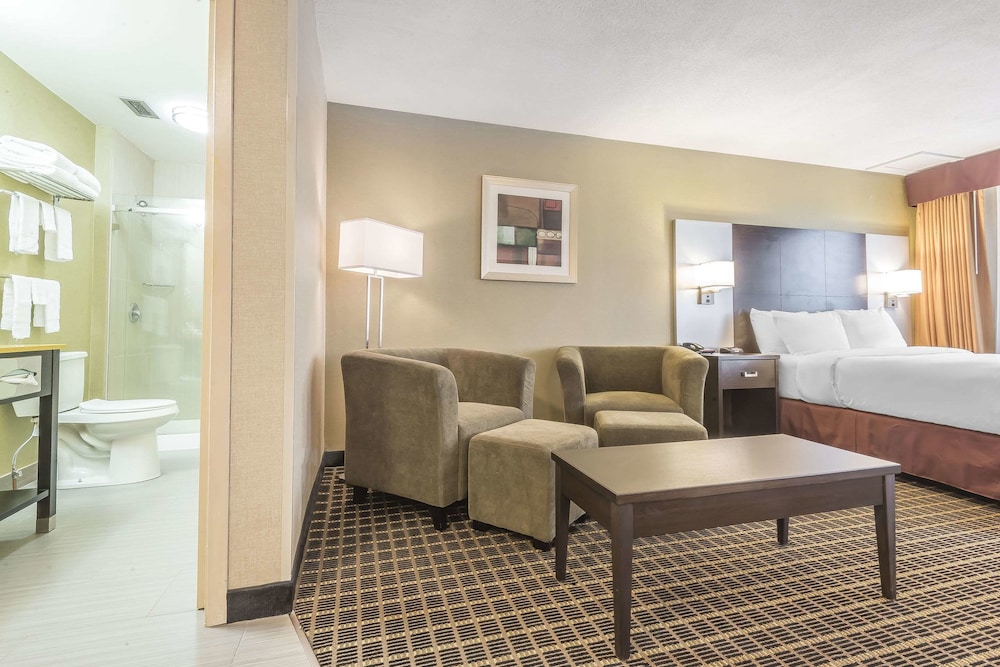 hotel room with a couch, chair and coffee table