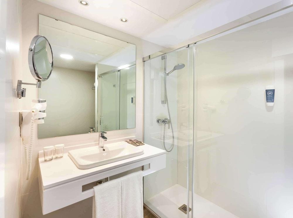 Relax in a sleek, modern bathroom oasis.