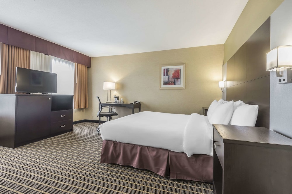 hotel room with a king size bed and flat screen tv