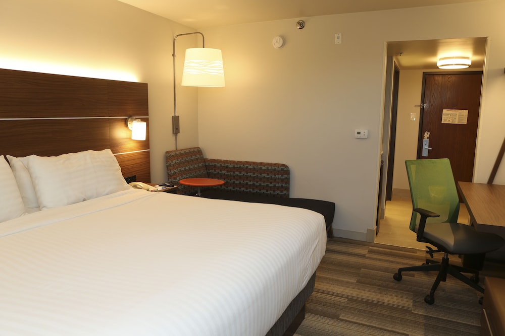 hotel room with a bed, desk, and chair
