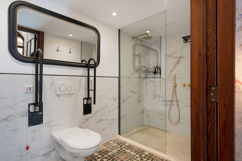 bathroom with a toilet and a walk - in shower