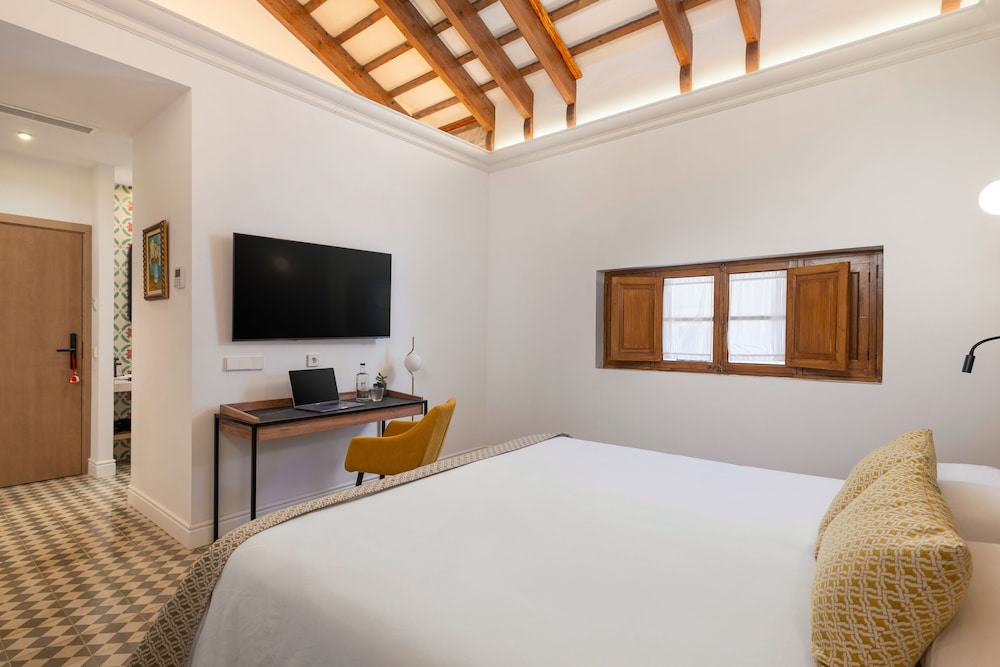 bedroom with a large bed and a flat screen tv