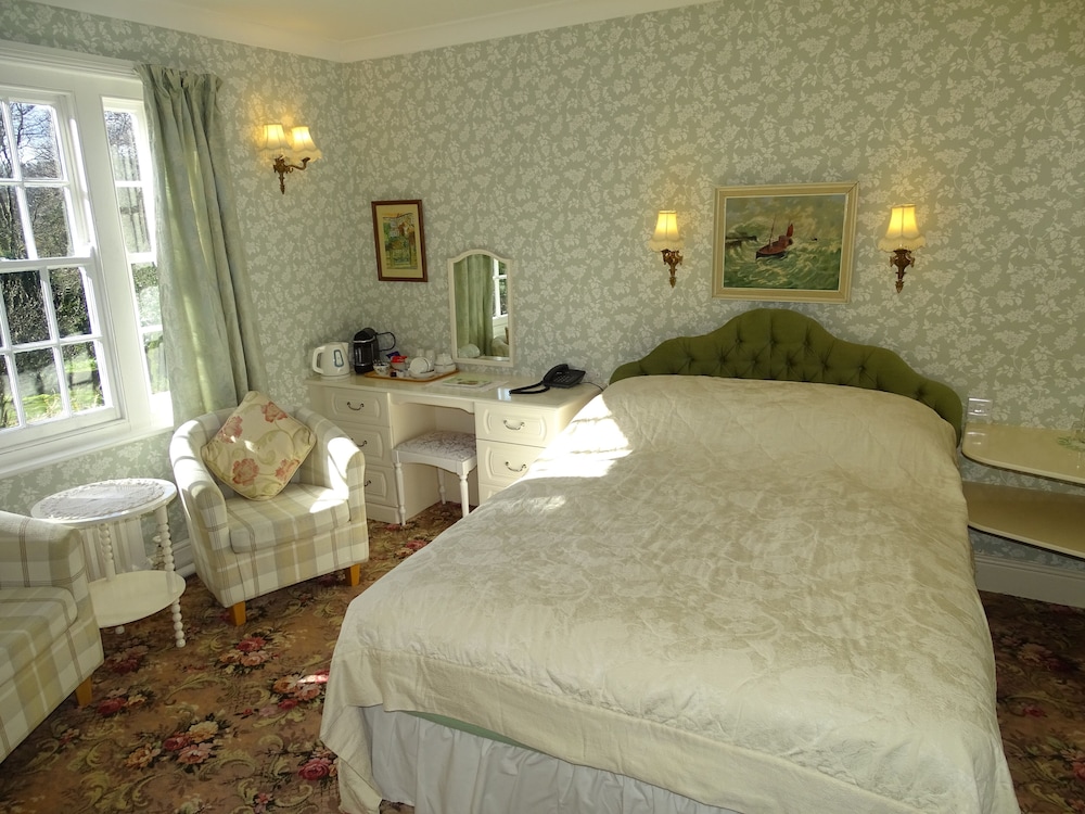 bedroom with a bed, chair, desk and window