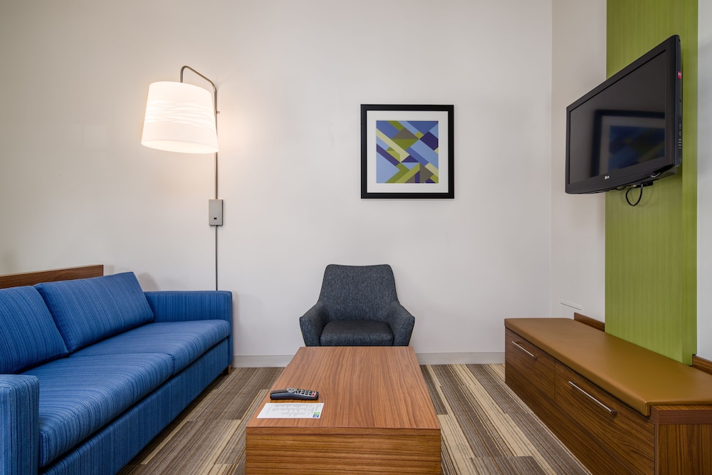 living room with blue couches and a flat screen tv