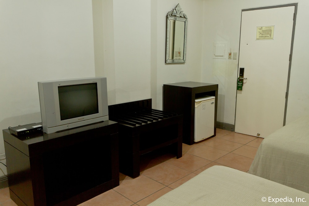 small room with two beds and an old television set