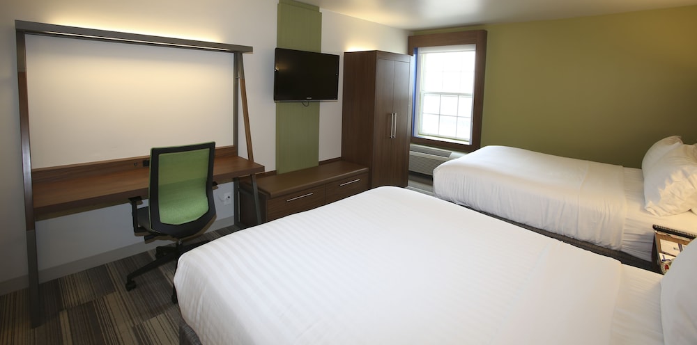 hotel room with two beds and a flat screen tv