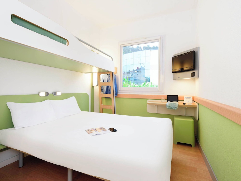 Room with a large bed and a bunk bed