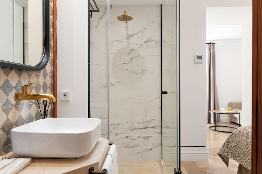 bathroom with a walk in shower and a white sink