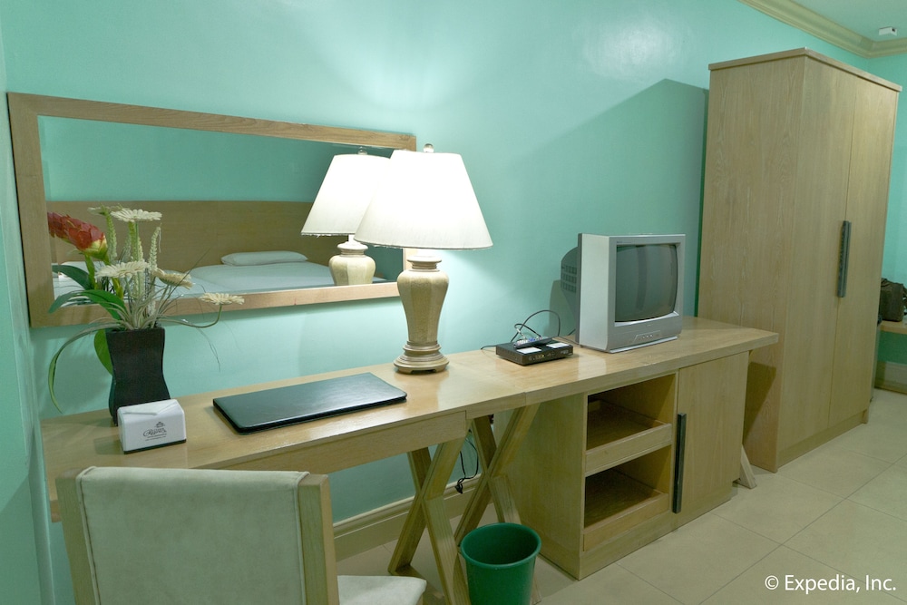 room with blue walls and light wood furniture, including the desk