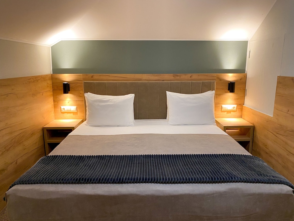 A standard double room with one bed in the basement without a window