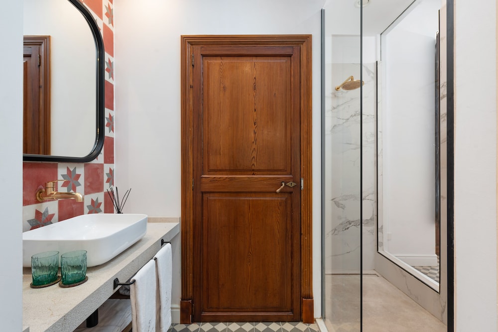 bathroom with red and white tiles on the walls and floor