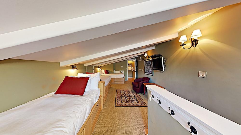 Attic bedroom with two single beds and sloped ceiling
