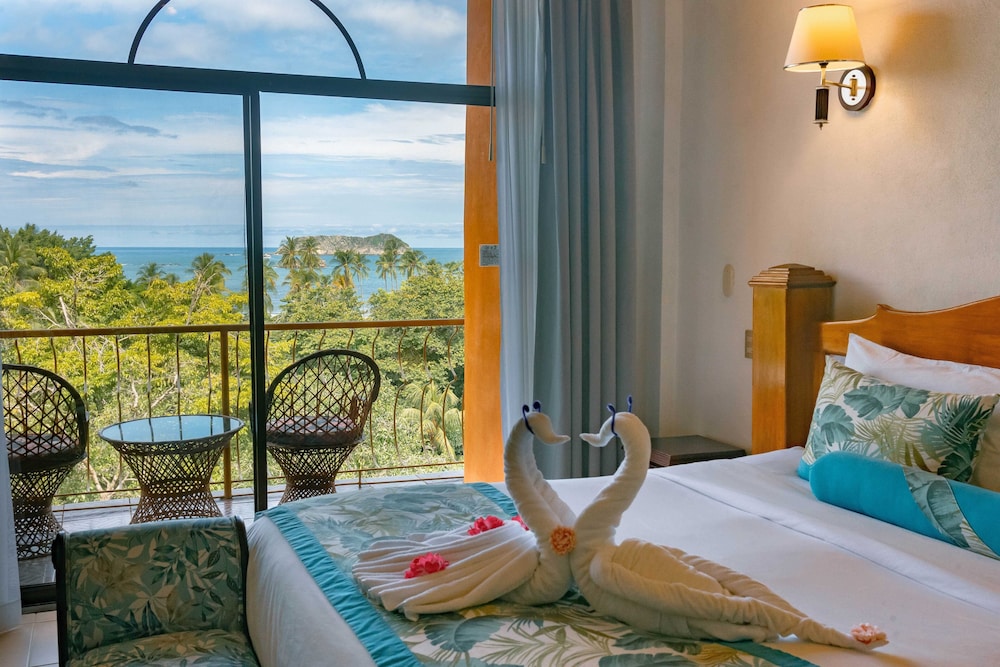 Deluxe Room with Partial Ocean View, One king bed - Photo 1