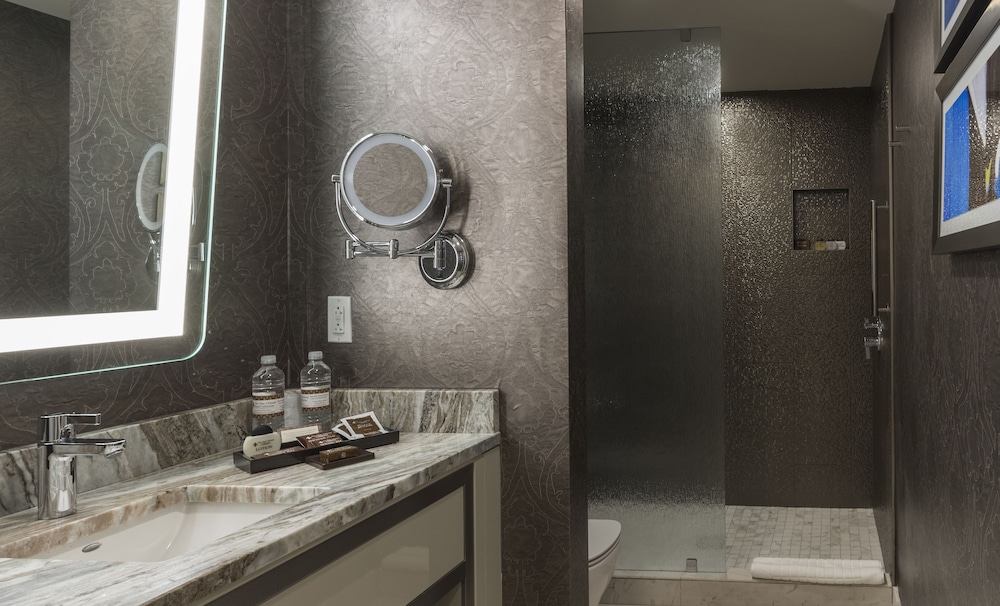 marble sink with mirror and walk-in shower