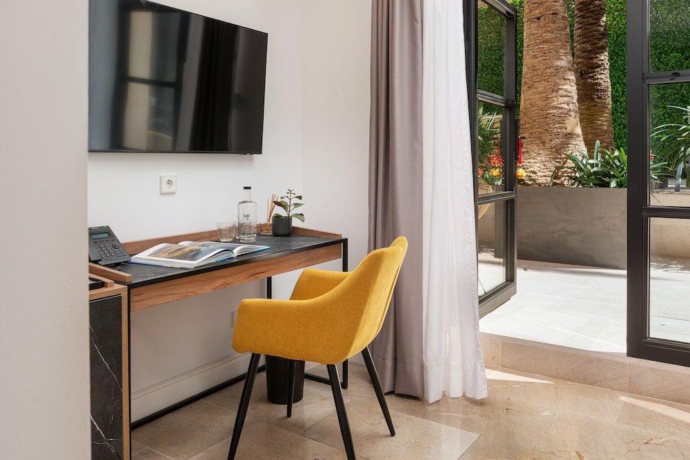 desk with a yellow chair and a flat screen tv