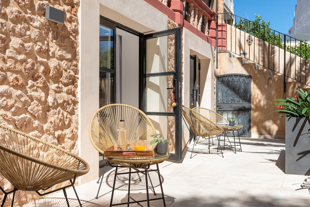 patio with wicker chairs and a table on it