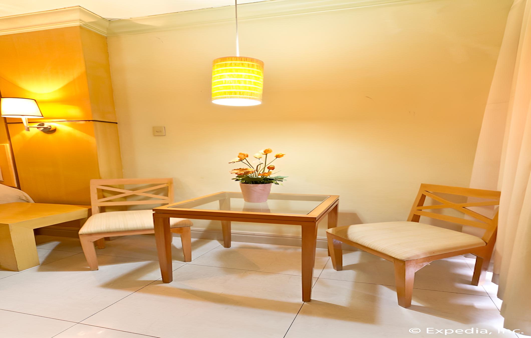 small dining room with yellow accents and white tile flooring