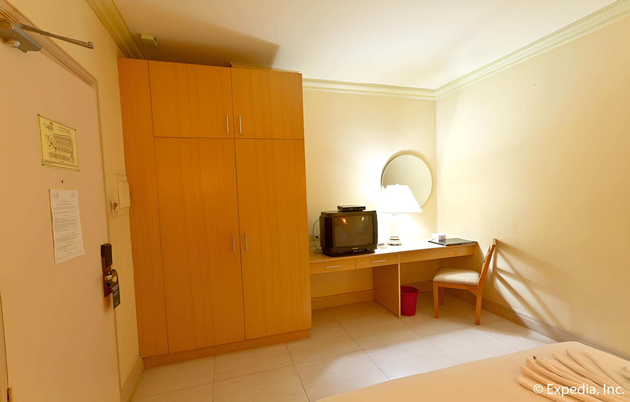 bedroom with an extra bed and desk in it?