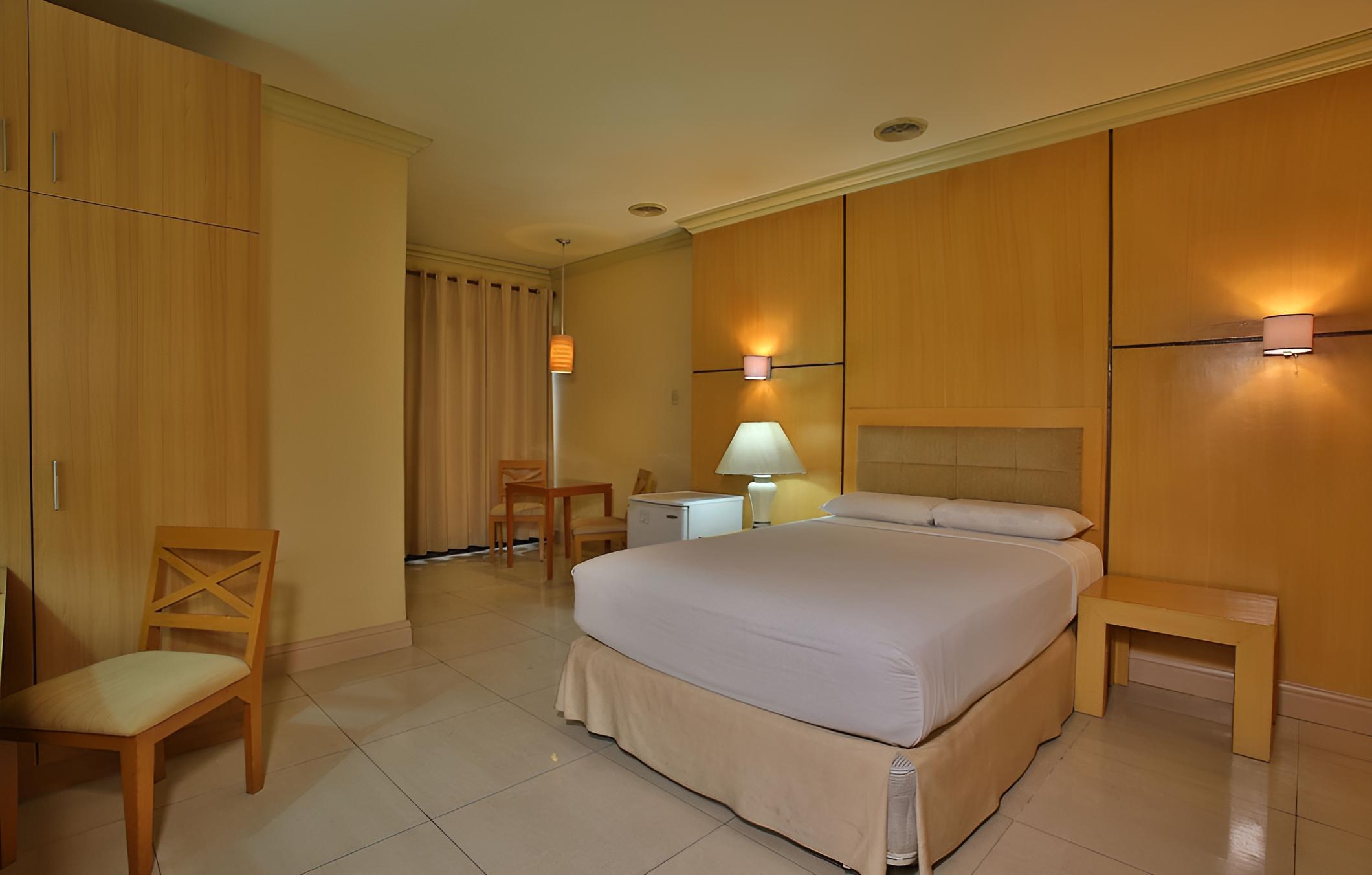 hotel room with the bed and desk in it?