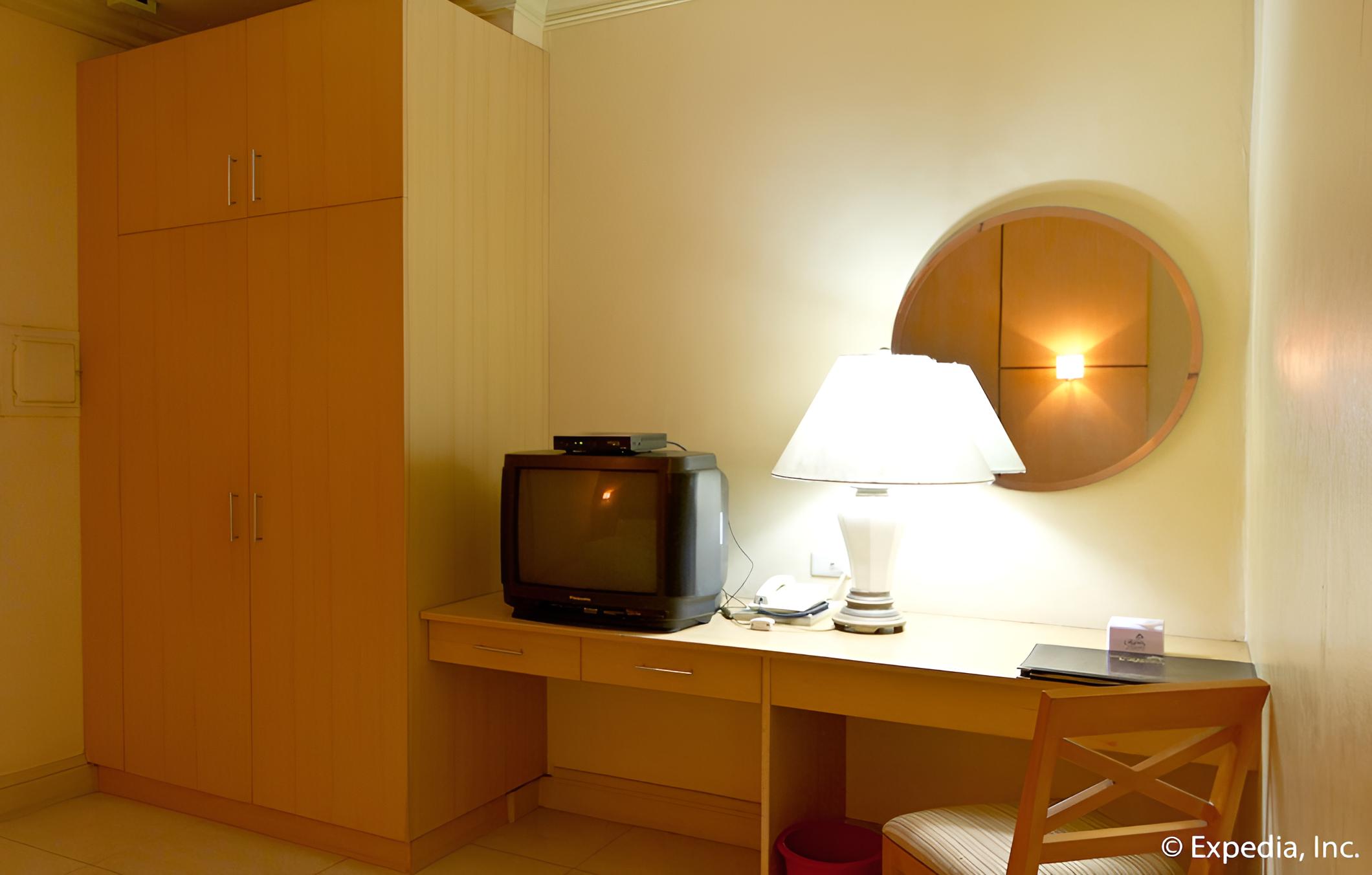 small room with an old television and desk in it